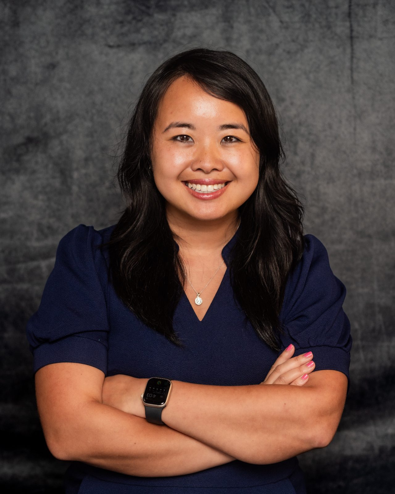 Erica C. Chen, smiling, arms crossed