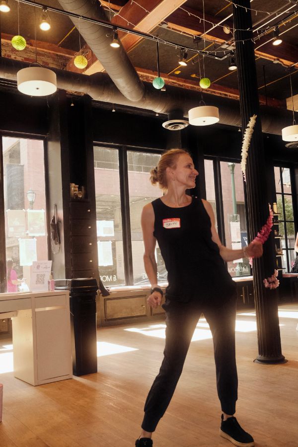 A participant mid-shimmy, smiling