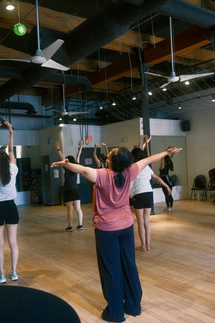 Participants reaching wide across the room