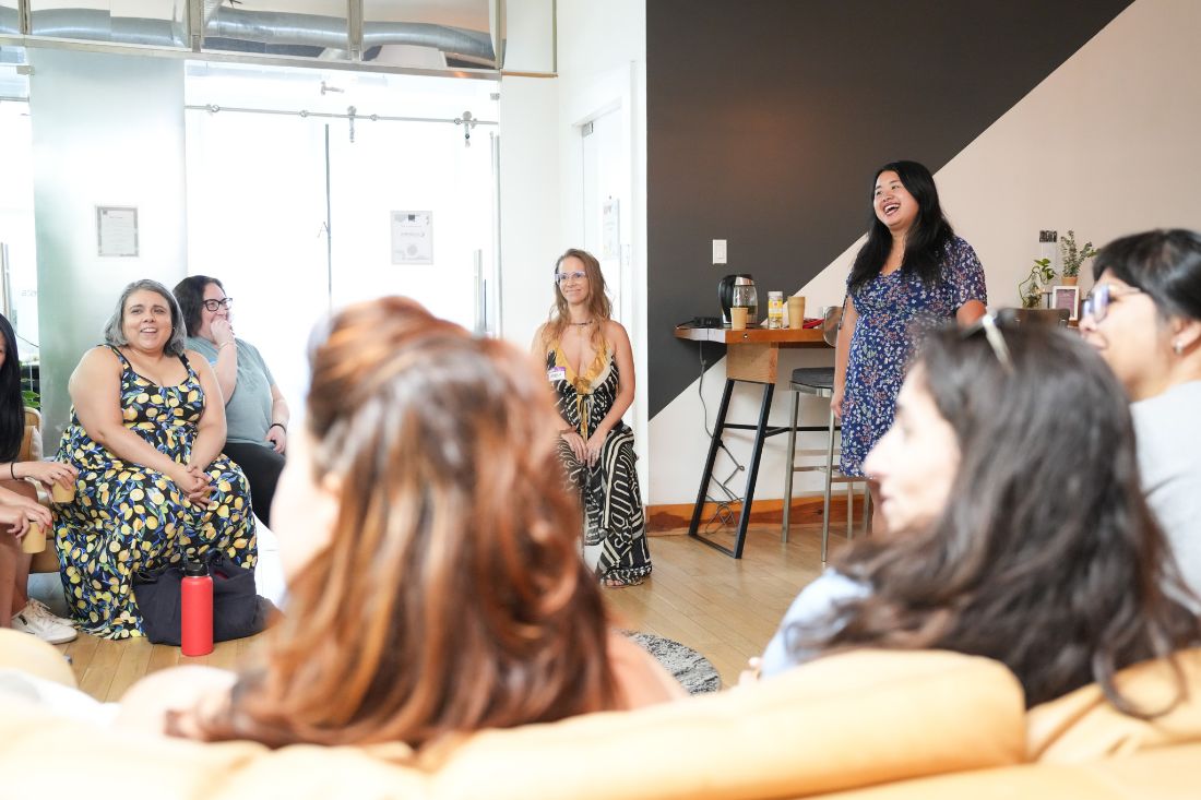 Erica leading a seated circle of participants