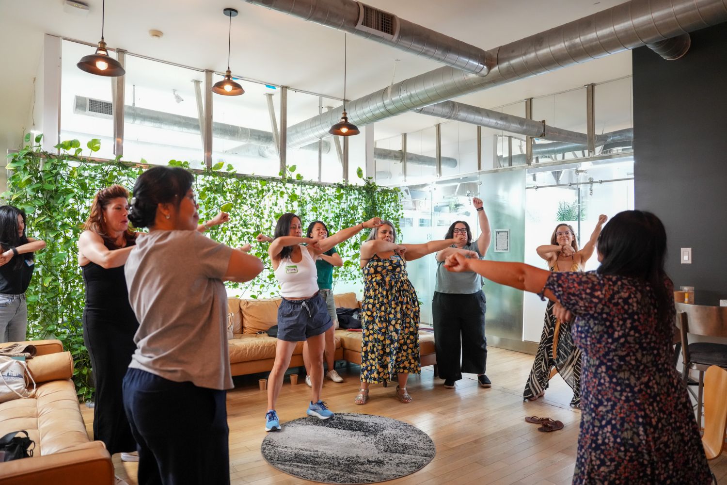 Participants standing with arms outstretched during an activity