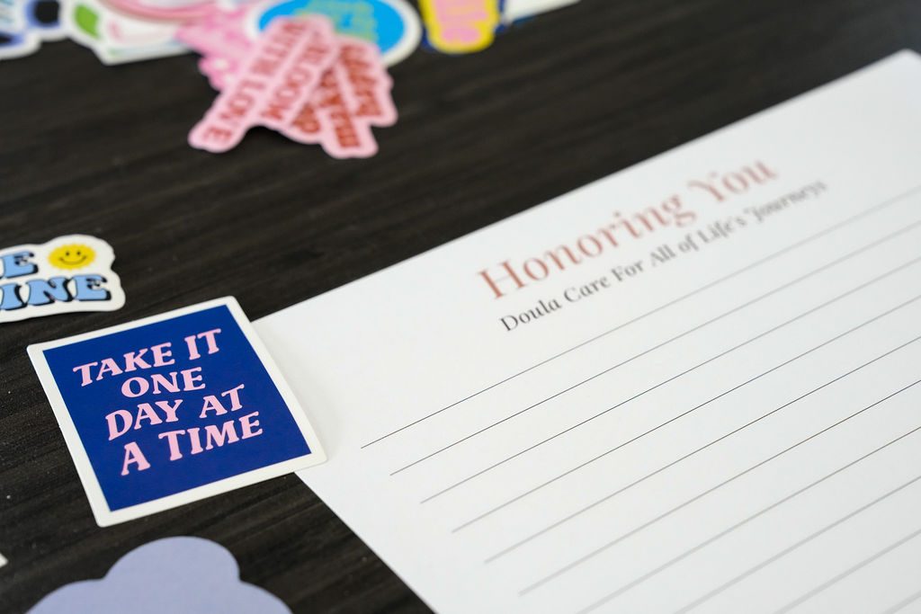 A blank page waiting, stickers scattered beside it