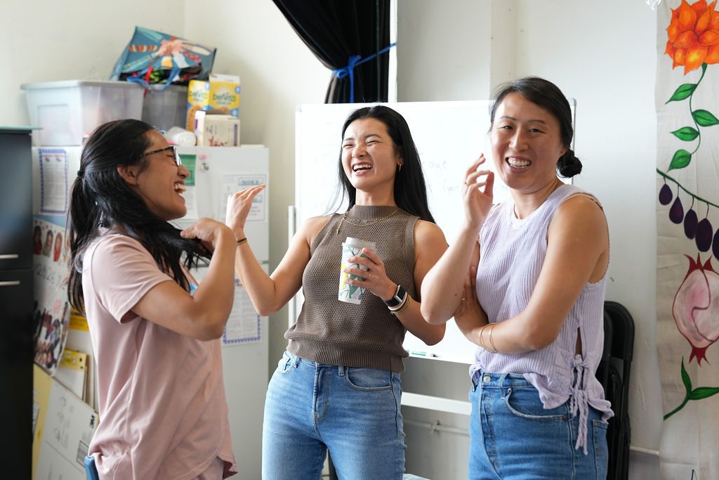 Three participants caught mid-laugh